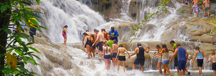 Group of people climbing the Dunn's River Falls | Book Jamaica Excursions | bookjamaicaexcursions.com | Karandas Tours
